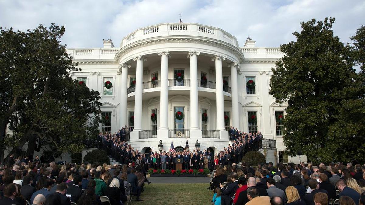 President Donald Trump surrounded by members of congress and supporters as he speaks during an event on the South Lawn of the White House in Washington, to acknowledge the final passage of tax overhaul legislation by Congress. Trump’s unpredictable, pugnacious approach to the presidency often worked against him as Republicans navigated a tumultuous but ultimately productive year in Congress.