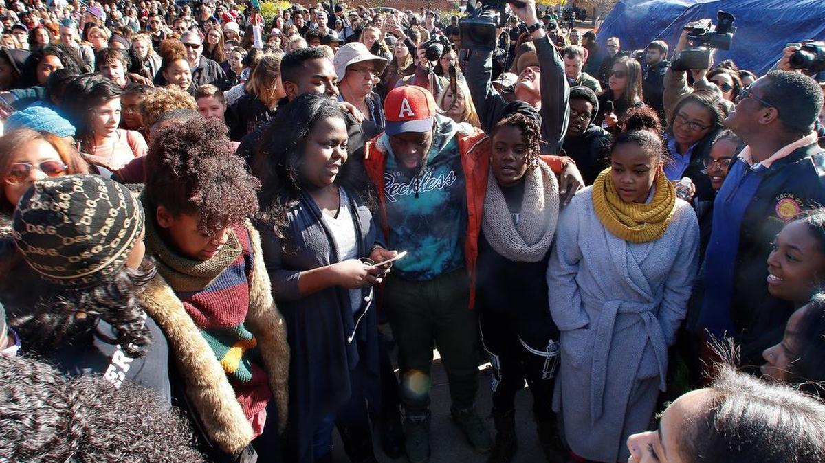 Supporters gather after the announcement that University of Missouri System President Tim Wolfe would resign, in Columbia, Mo.