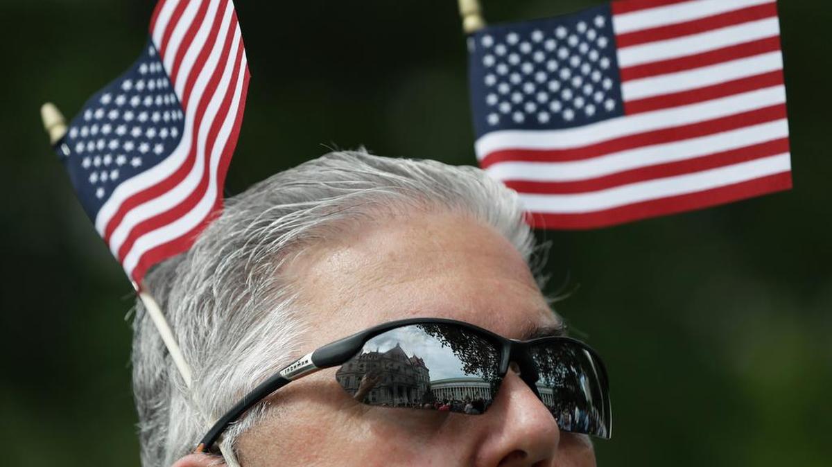 A man wears American flags during an election prayer rally Thursday in Albany, N.Y.