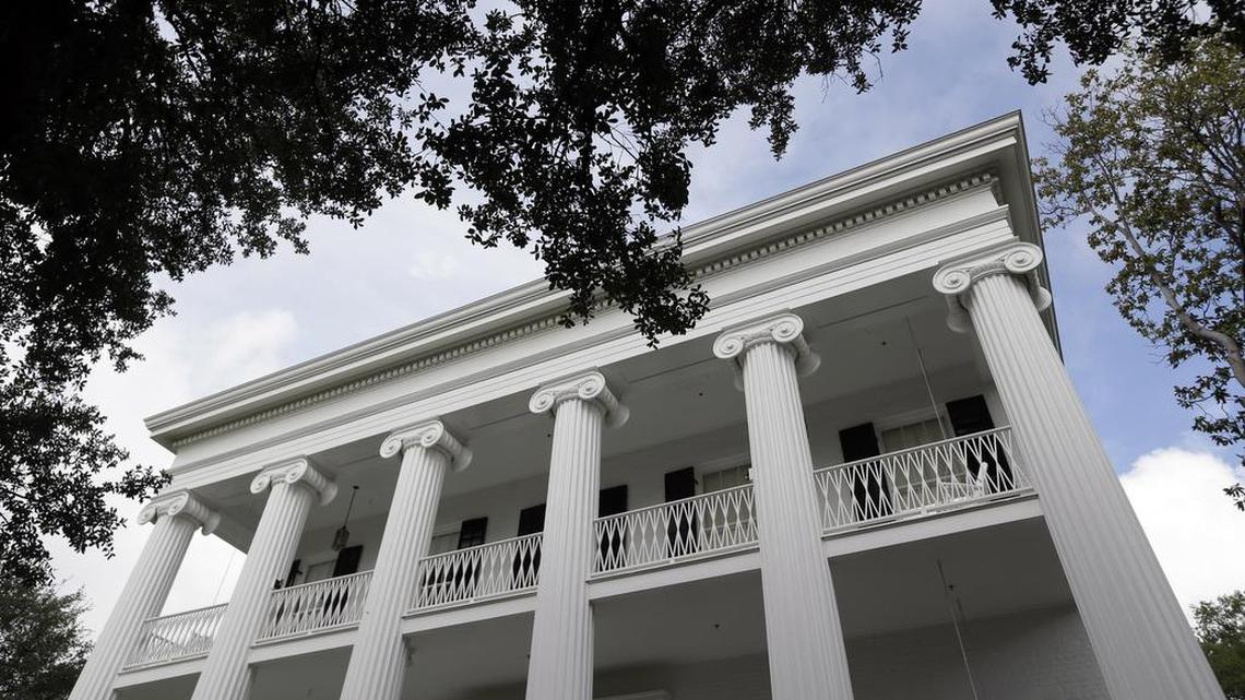 The Texas Governor's Mansion is framed by an oak tree in Austin.