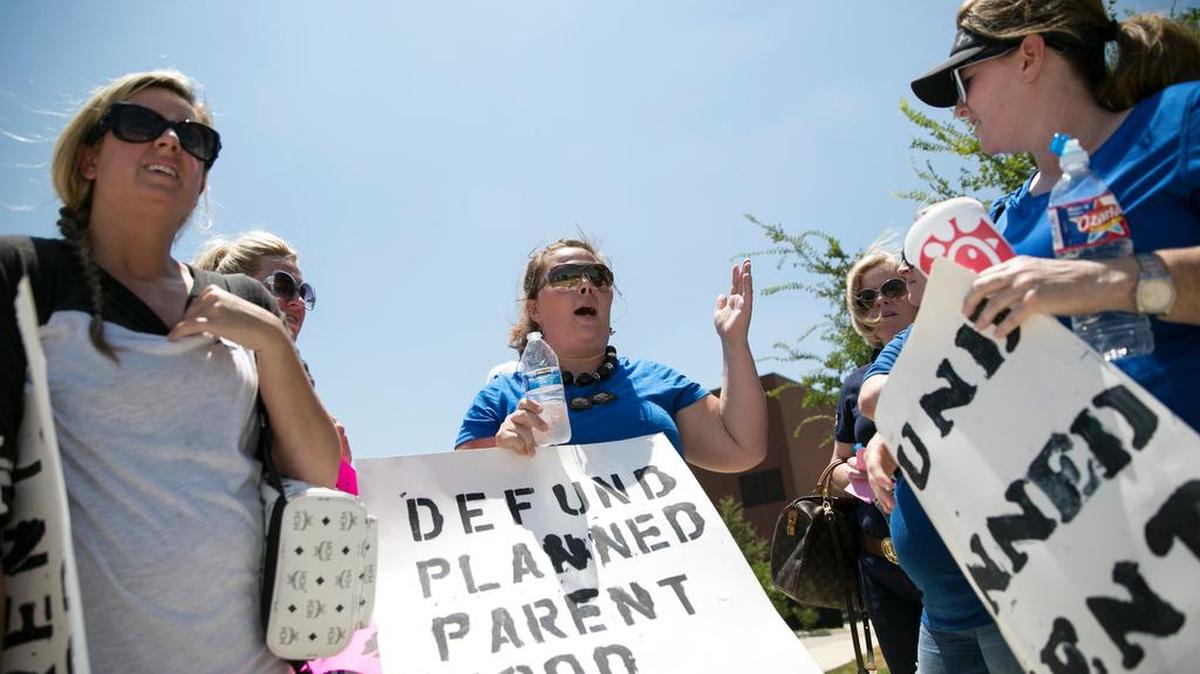 
Mary Daley, center, speaks with fellow protesters during an anti-abortion rally at Planned Parenthood in Fort Worth on July 28.
