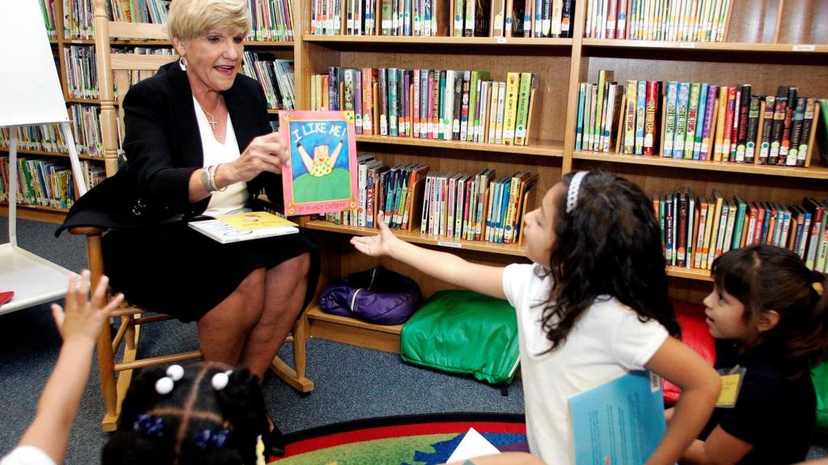 Aliyah Burdos, 5, receives a copy of I Like Me from Mayor Betsy Price Sept. 26 during the announcement of the Fort Worth Literacy Partnership at Oakhurst Elementary school in Fort Worth.