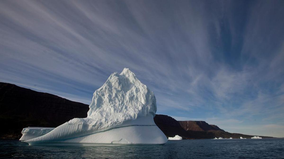 In this July 21, 2011 file photo, an iceberg floats in the sea near Greenland. Melting ice due to global warming is shifting the way the Earth wobbles on its polar axis, a NASA study has found.