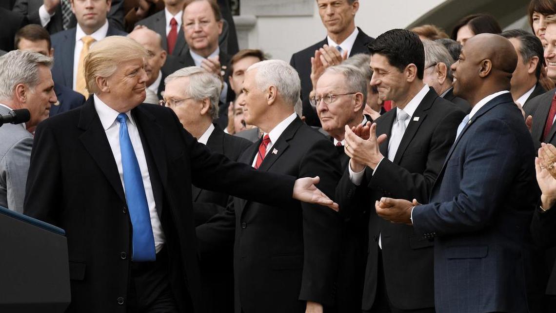 President Donald Trump acknowledges House Speaker Paul Ryan during a celebration of the tax bill's passage with members of the House and Senate in 2017.