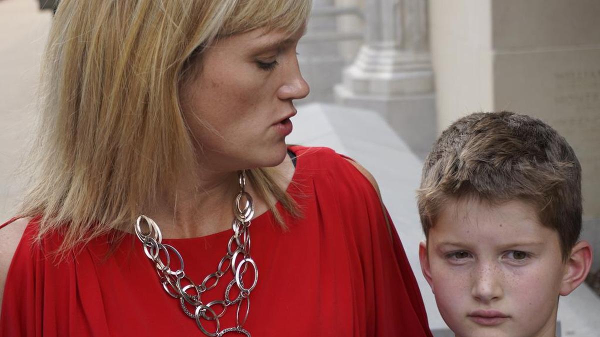 Amber Briggle with her transgender son, Max, outside Eldon B. Mahon Federal Court building in Fort Worth in 2016.
