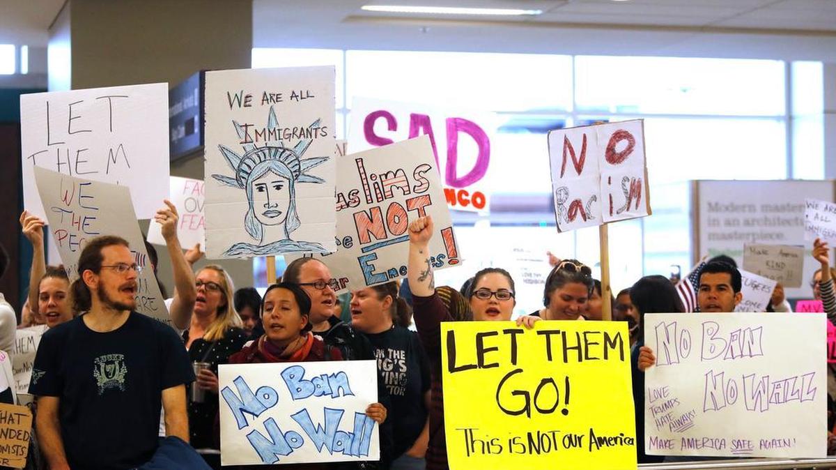 Protesters showed support Sunday for the travel detainees held at DFW Airport due to President Trump’s immigration order.