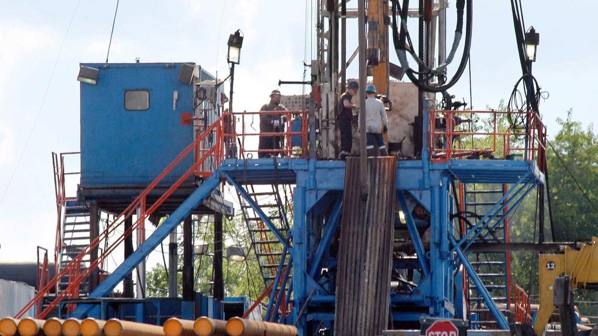 A crew works on a gas drilling rig at a well site for shale based natural gas in Zelienople, Pa. in 2012.
