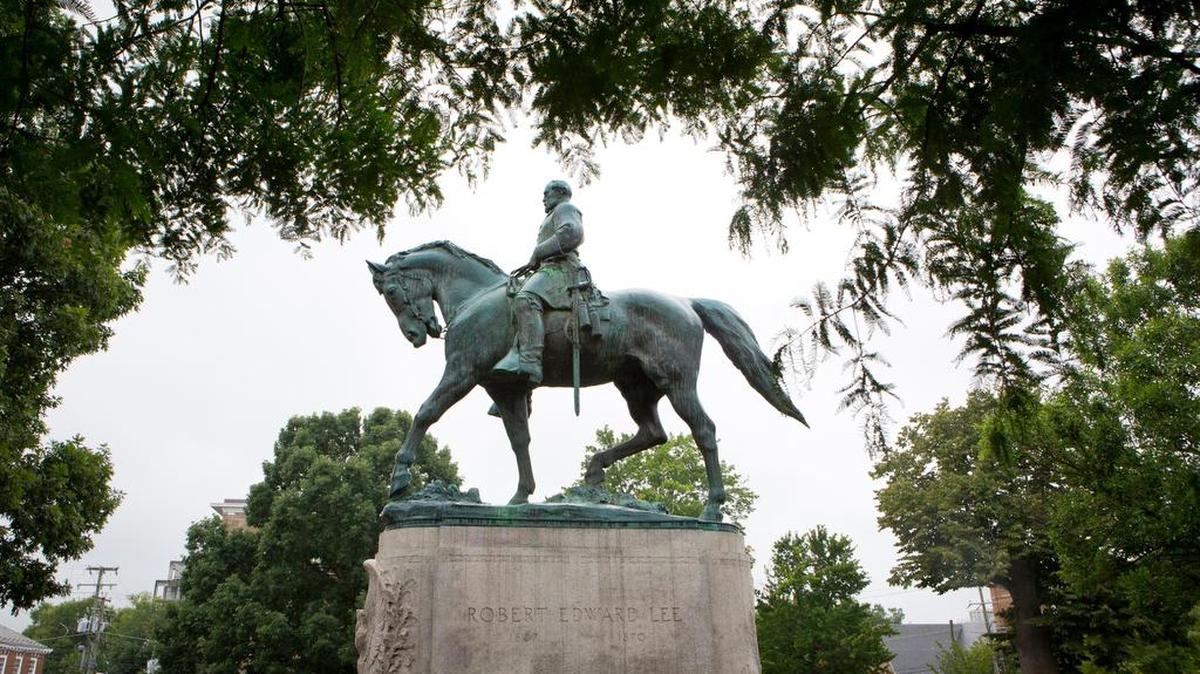 FILE-In this Tuesday, Aug. 15, 2017 file photo, a statue of Confederate general Robert E. Lee sits in Emancipation Park, in Charlottesville, Va. The deadly rally by white nationalists in Charlottesville, Aug. 12, 2017, is accelerating the removal of Confederate statues in cities across the nation.