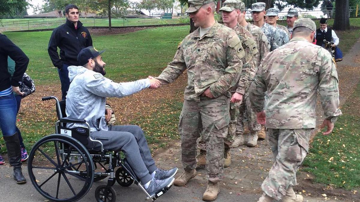 Soldiers shake hands Oct. 24 with Army veteran Chris Mintz, shot by a campus gunman Oct. 1 in Roseburg, Ore.
