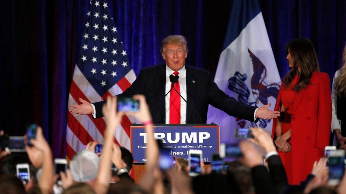 Donald Trump gestures to the crowd at his caucus night rally Monday in West Des Moines, Iowa.