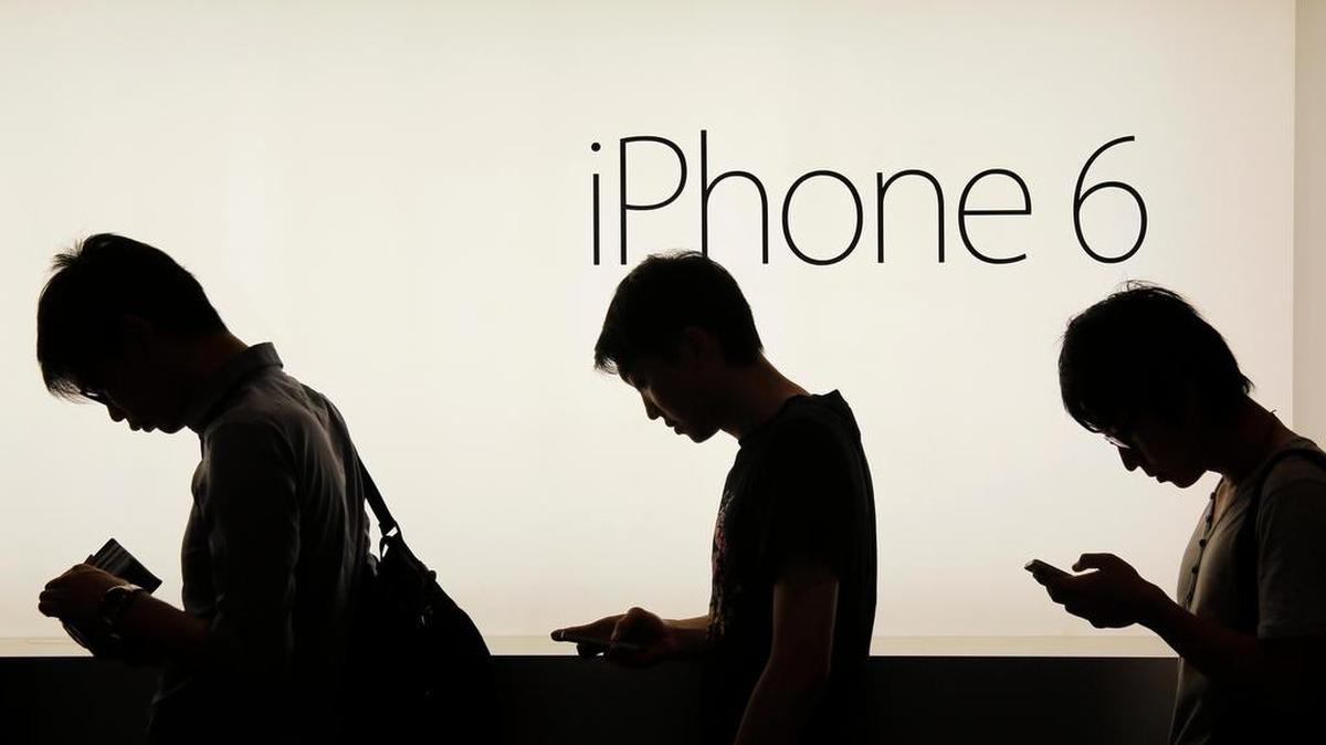 People wait to buy the new Apple iPhone 6 and 6 Plus devices outside an Apple store in Hong Kong in 2014. Apple said they slow down older iPhones because of degrading batteries.