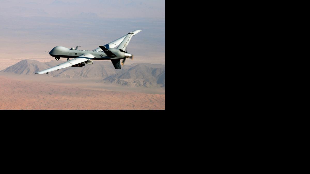 
 A Predator drone, armed with missiles, flies over Afghanistan. 
