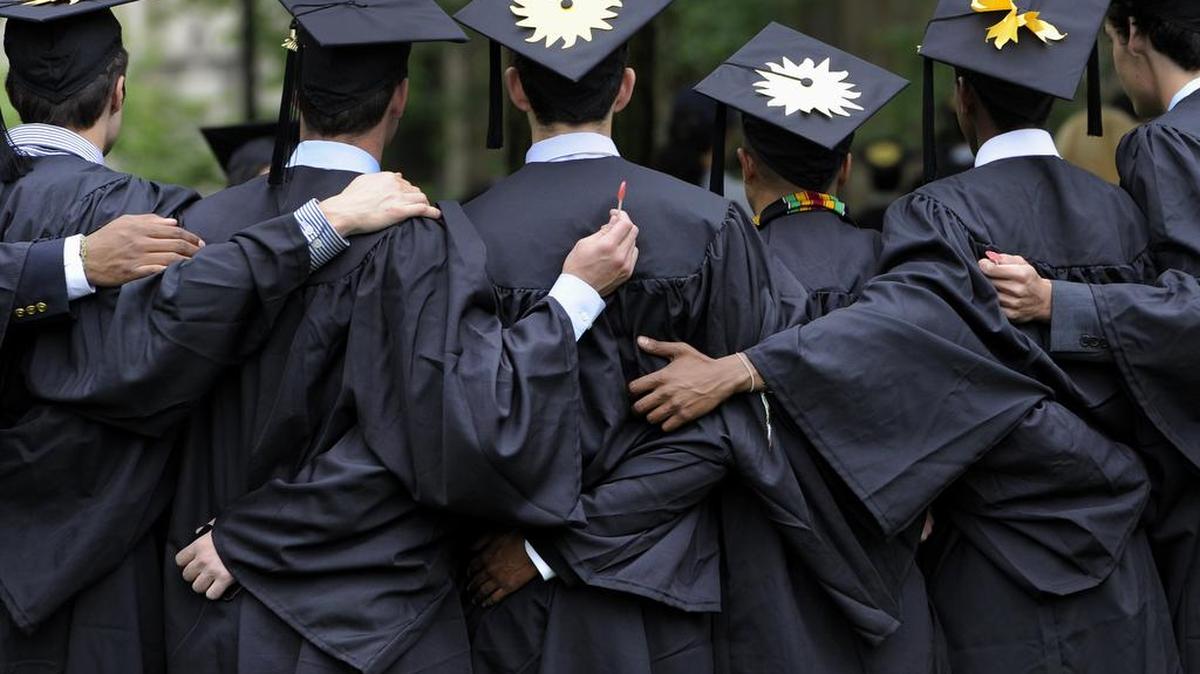 Graduates pose for photographs during commencement at Yale University in New Haven, Conn.