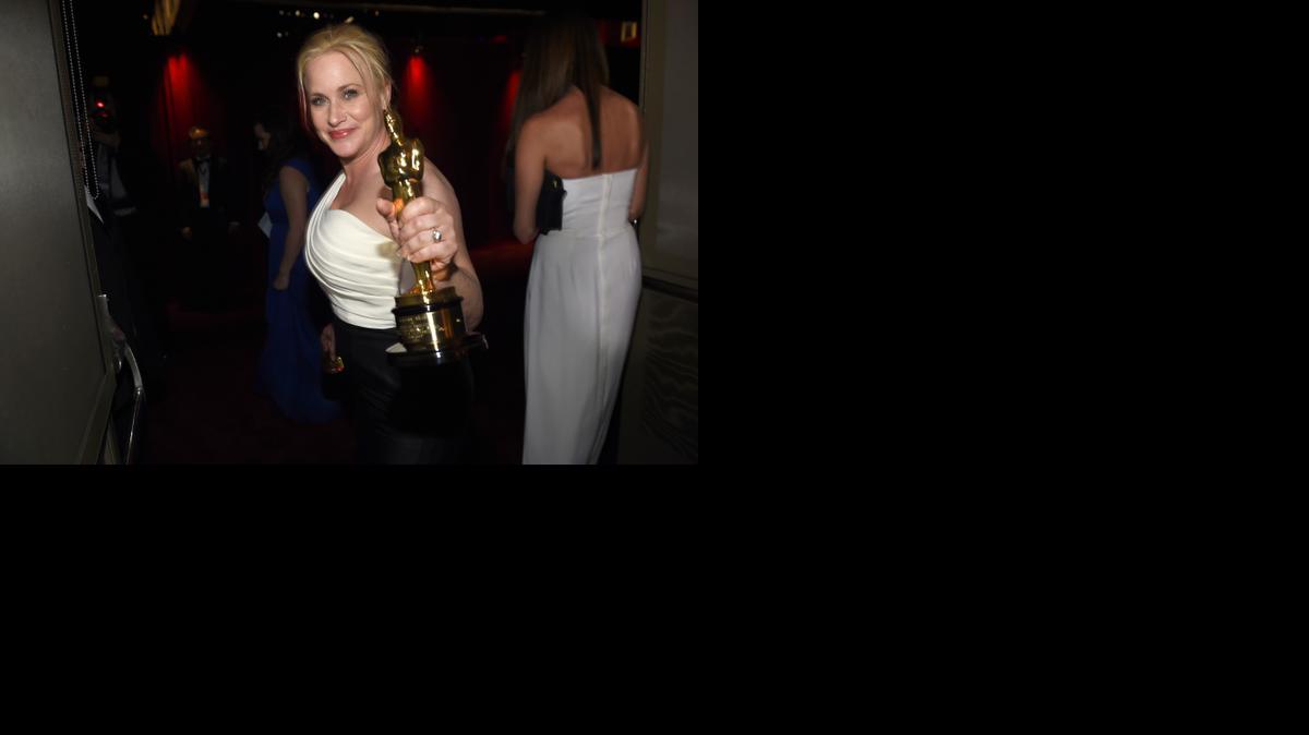
Patricia Arquette shows off her Oscar after using her acceptance speech to highlight equal pay for women. 

