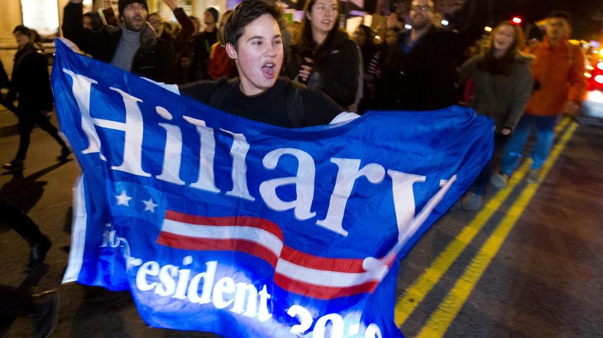 A demonstrator holds a banner as people protest during a Nov. 12 march in downtown Washington in opposition to President-elect Donald Trump.