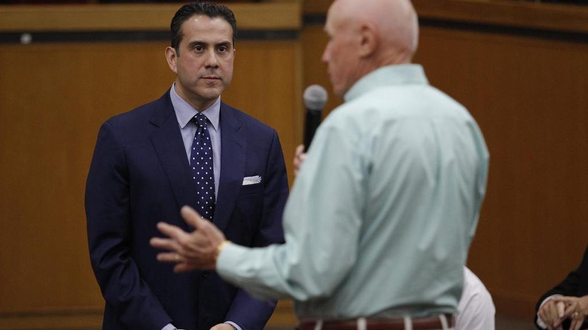 Arlington City Councilman Robert Rivera (left) listens to resident Tom McMahan during a meeting at City Hall.