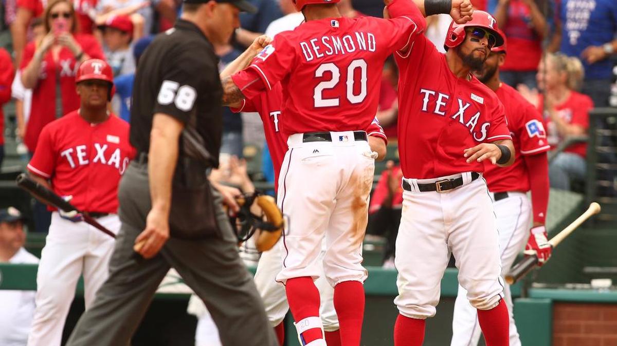 Texas Rangers Ian Desmond (20) and Rougned Odor (12) celebrate after a three-run homer May 15 at Globe Life Park.