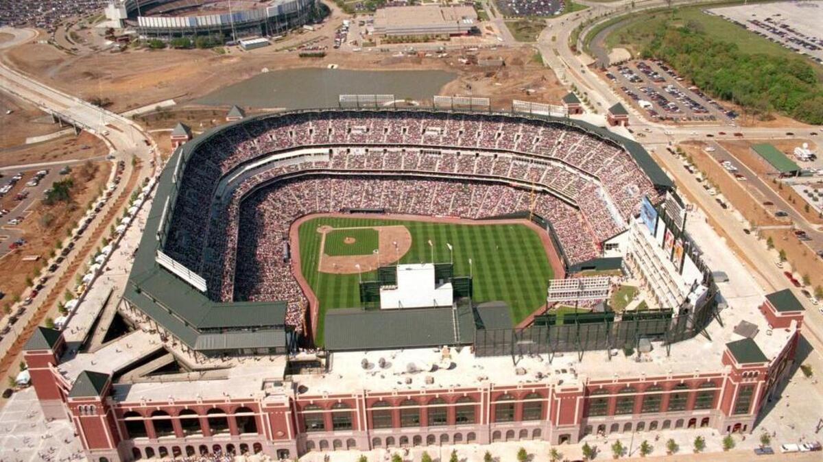 Archive photo from April 2, 1994, shows the new Ballpark in Arlington in foreground dwarfed the old Arlington Stadium seen in the upper left.
