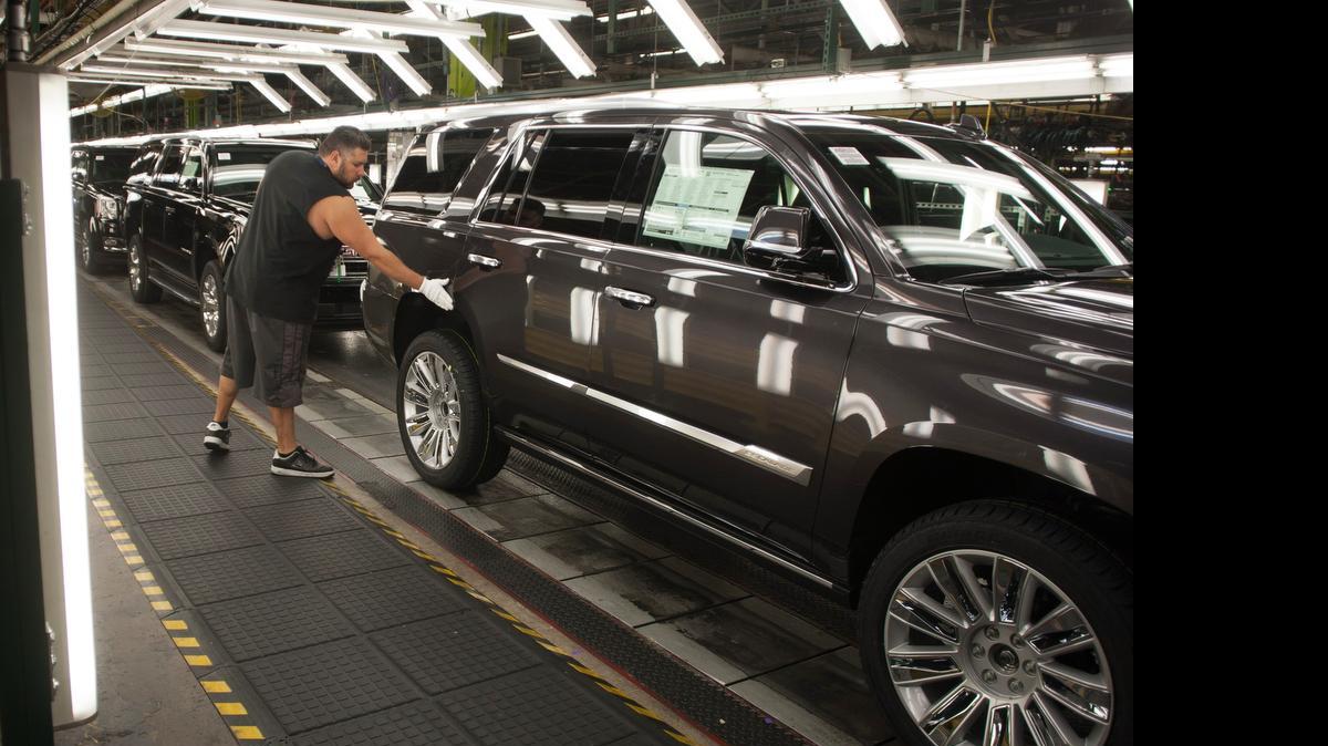 
Efren Martin II checks vehicles for flaws in the final line at the General Motors assembly plant in Arlington. 
