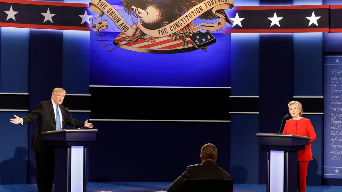 Republican Donald Trump answers a question as Democrat Hillary Clinton listens during Monday’s debate.