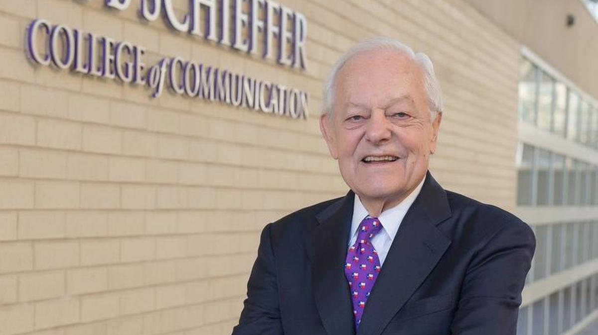 Bob Schieffer’s new book, “Overload,” addresses how critical local news organizations are to their communities and how hard it is to find relevant information in the digital age. Here he stands in front of the TCU communications school named after him.