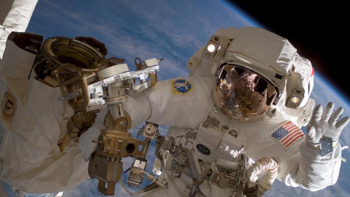 NASA astronaut Clay Anderson waves outside the International Space Station in 2007.