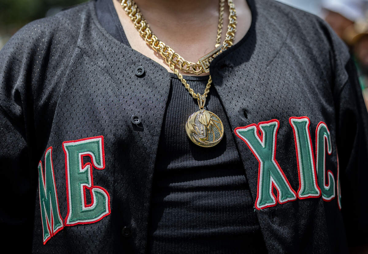 David Narro wears a Dallas Mavericks chain under his Mexico jersey during the FIFA Fan Festival on Thursday, June 11, 2026, at Fair Park in Dallas. The FIFA Fan Festival began with a live performance from a mariachi band.
