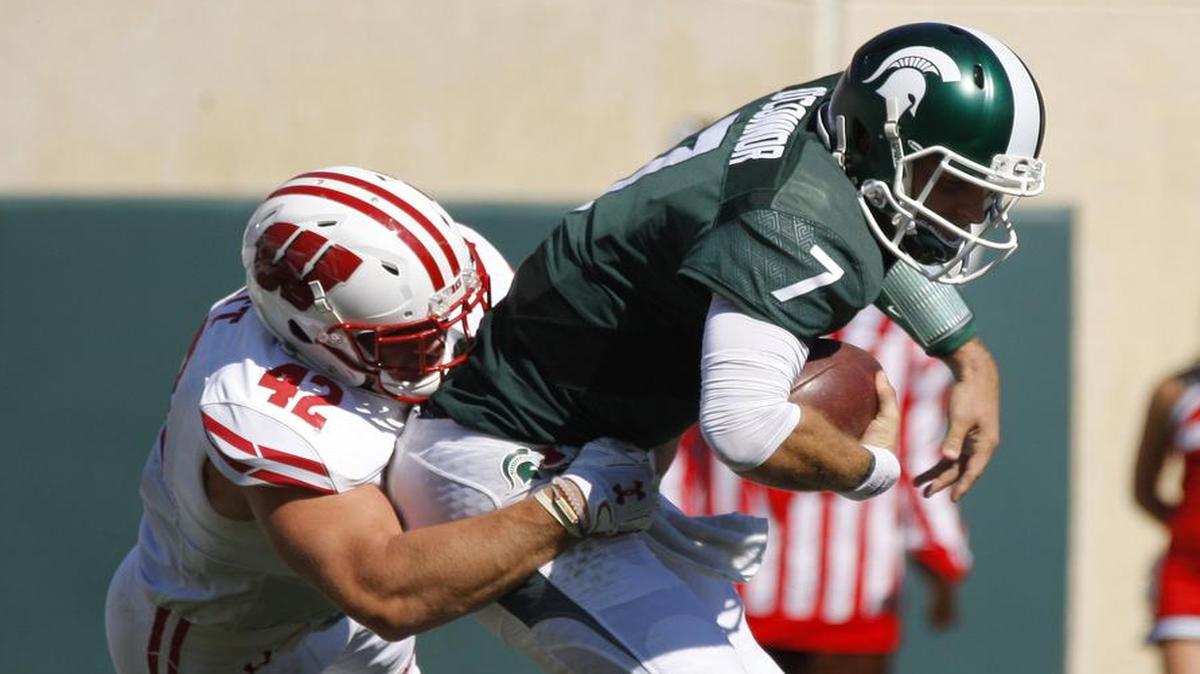 Wisconsin’s T.J. Watt, left, sacks Michigan State quarterback Tyler O’Connor on Saturday in the Badgers’ 30-6 victory. Wisconsin will play at Michigan on Saturday in a key battle of undefeated Big Ten teams. Coverage begins at 2:30 p.m. on ABC (WFAA/Ch. 8).