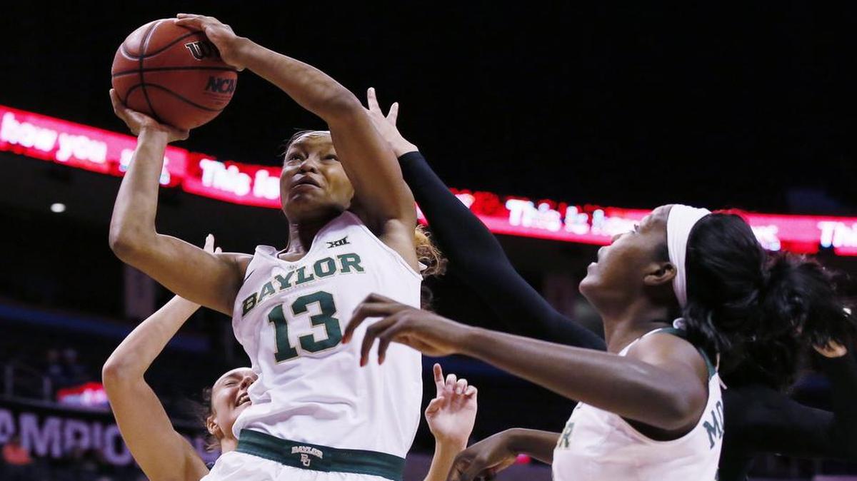 Baylor forward Nina Davis, left, (13) shoots in front of Kansas State forward Kaylee Page, left, and teammate Beatrice Mompremier, right, during Sunday’s victory in the Big 12 tournament semifinals. Baylor will take on West Virginia on Monday in the title game after the Mountaineers upset the Texas Longhorns on Sunday in the other semifinal game. Monday’s game will be telecast at 8 p.m. on FS1.