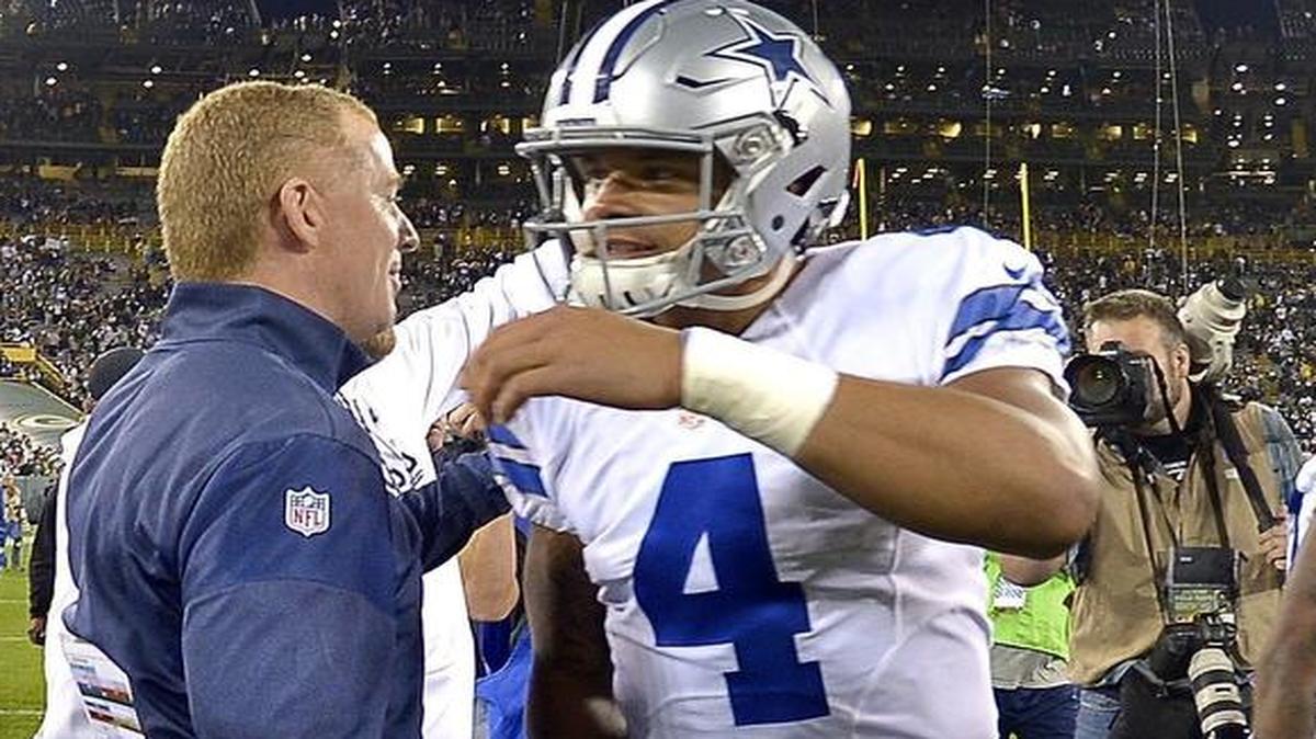 Dallas Cowboys head coach Jason Garrett gives a hug to quarterback Dak Prescott (4) after the Cowboys defeated the Green Bay Packers 30-16 at Lambeau Field in Green Bay, Wis., Sunday, Oct. 16, 2016. The Cowboys will have a rematch with the Packers in the NFC divisional round playoffs at 3:40 p.m. Sunday at AT&T Stadium in Arlington. The game is sold out. Telecast is on Fox (KDFW/4).