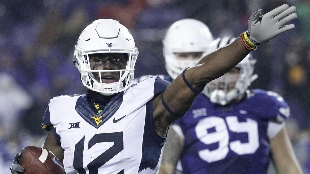 West Virginia wide receiver Gary Jennings (12) looks to point the Mountaineers in the direction of a victory in the Heart of Dallas Bowl. (AP Photo/Charlie Riedel)