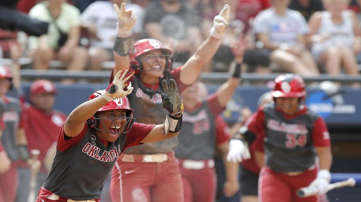 Kelsey Arnold, left, and Nicole Mendes of Oklahoma celebrate a run during Sunday’s victory over Oregon in the women’s College World Series in Oklahoma City. The Sooners advanced to the best-of-three championship series against Florida, which started Monday. Game 2 is scheduled for 7 p.m. Tuesday on ESPN.