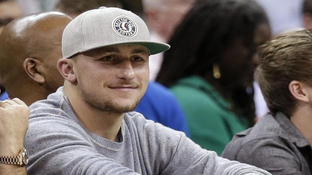 Then-Cleveland Browns quarterback Johnny Manziel watches the second half of an NBA basketball game between the Oklahoma City Thunder and the Cleveland Cavaliers in Cleveland in this 2015 photo. The 24-year-old player said recently he's trying to be "a good person" and suggested he's stopped partying. He has indicated he wants to resume his NFL career.