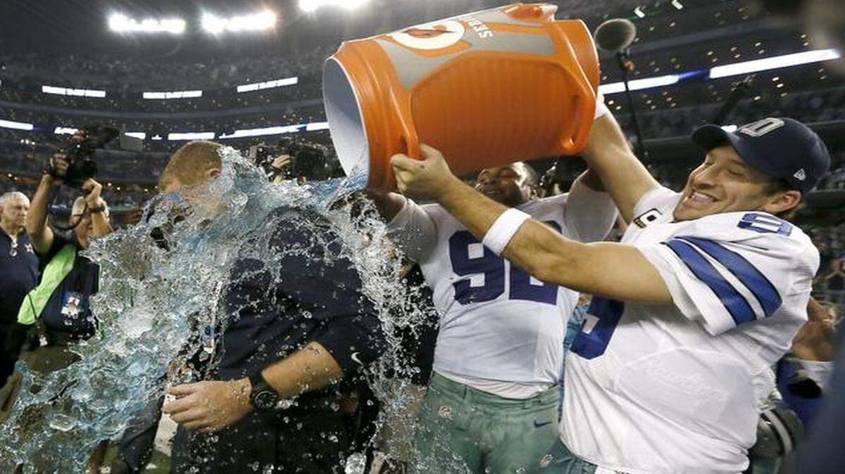 
Cowboys coach Jason Garrett is doused by Jeremy Mincey, center, and Tony Romo after the team beat the Colts and clinched the NFC East title.


