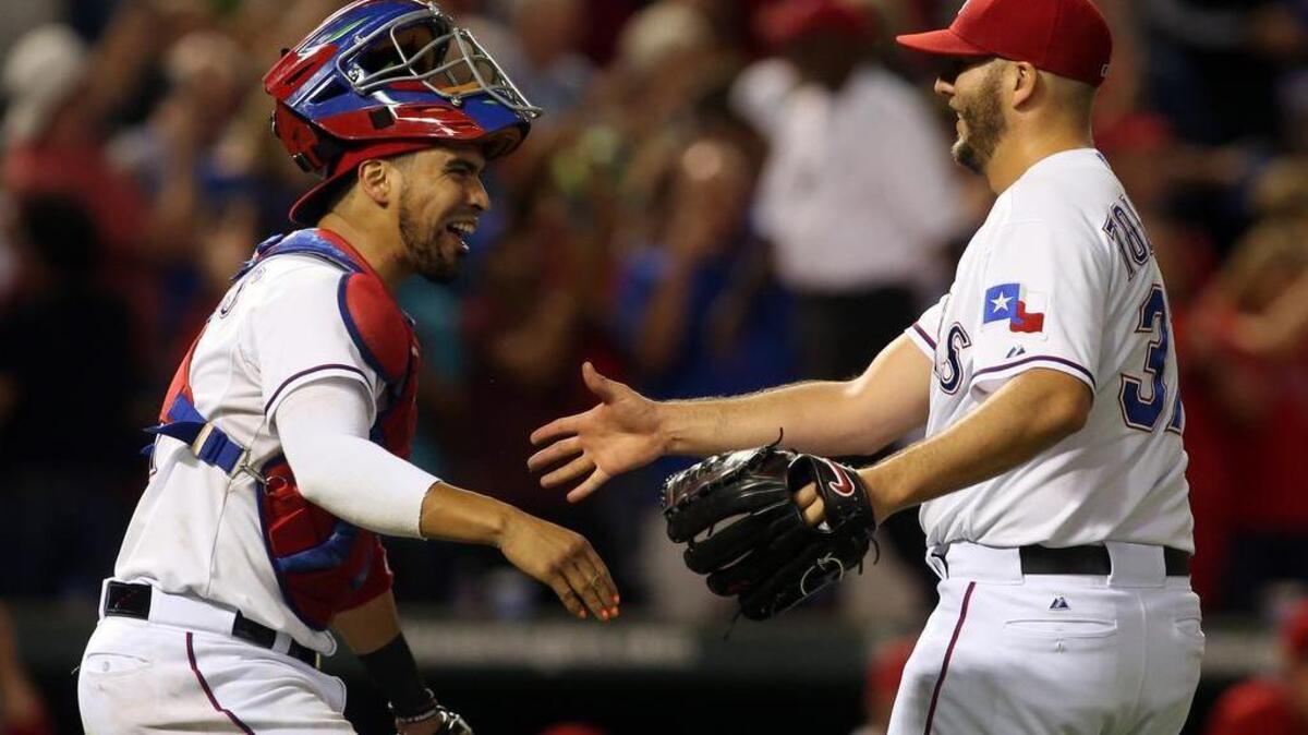 
Texas Rangers catcher Robinson Chirinos celebrates the save by relief pitcher Shawn Tolleson as the Rangers beat the Los Angeles Angels 5-3 at Globe Life Park on Thursday to clinch a playoff spot.
