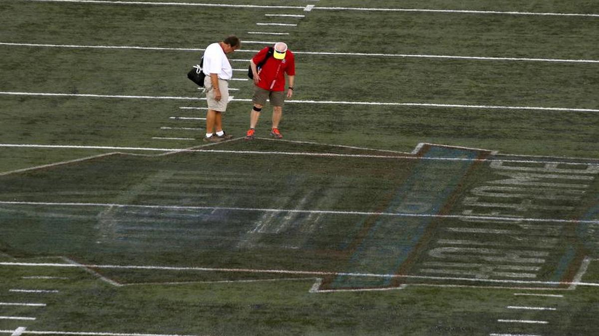Workers inspect the field before last year’s Pro Football Hall of Fame Game, which was canceled because of poor field conditions in Canton, Ohio. The Dallas Cowboys and Arizona Cardinals hope the field is in good shape for this year’s game, which is scheduled for 7 p.m. Thursday on NBC (KXAS/Ch. 5).