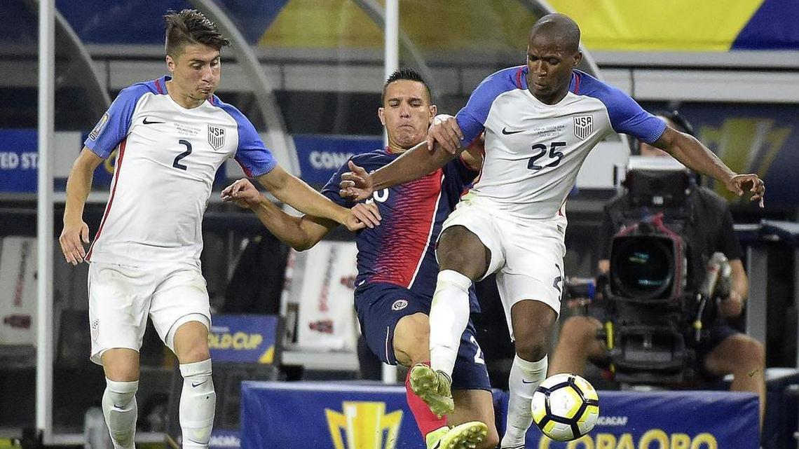 U.S.A. defender Jorge Villafana (2) and U.S.A. midfielder Darlington Nagbe (25) battle with Costa Rica midfielder David Guzman (20) for the ball.
