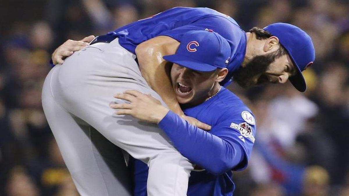 
Cubs pitcher Jake Arrieta gets a lift from first baseman Anthony Rizzo after the four-hit wild-card shutout. 
