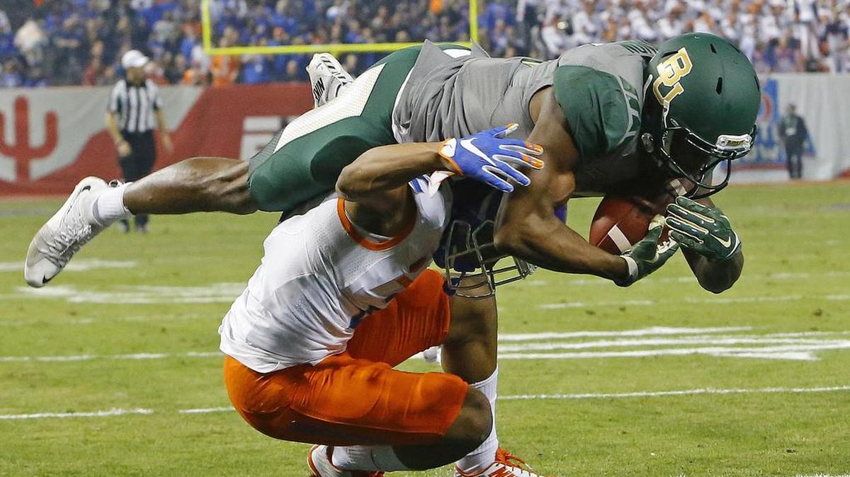 Baylor wide receiver KD Cannon rides Boise State cornerback Jonathan Moxey into the end zone at the end of a 30-yard touchdown reception in Tuesday night’s Cactus Bowl in Phoenix.