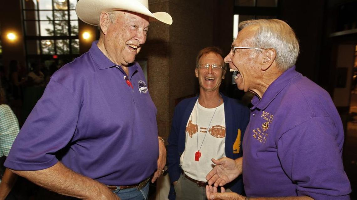 Chuck Curtis (left) shares a laugh with Pete Ragus at a reception for the “Texas High School Football: More Than the Game” exhibit at the Bob Bullock Texas State History Museum in Austin on Aug. 8, 2011. Curtis died Monday at age 80.