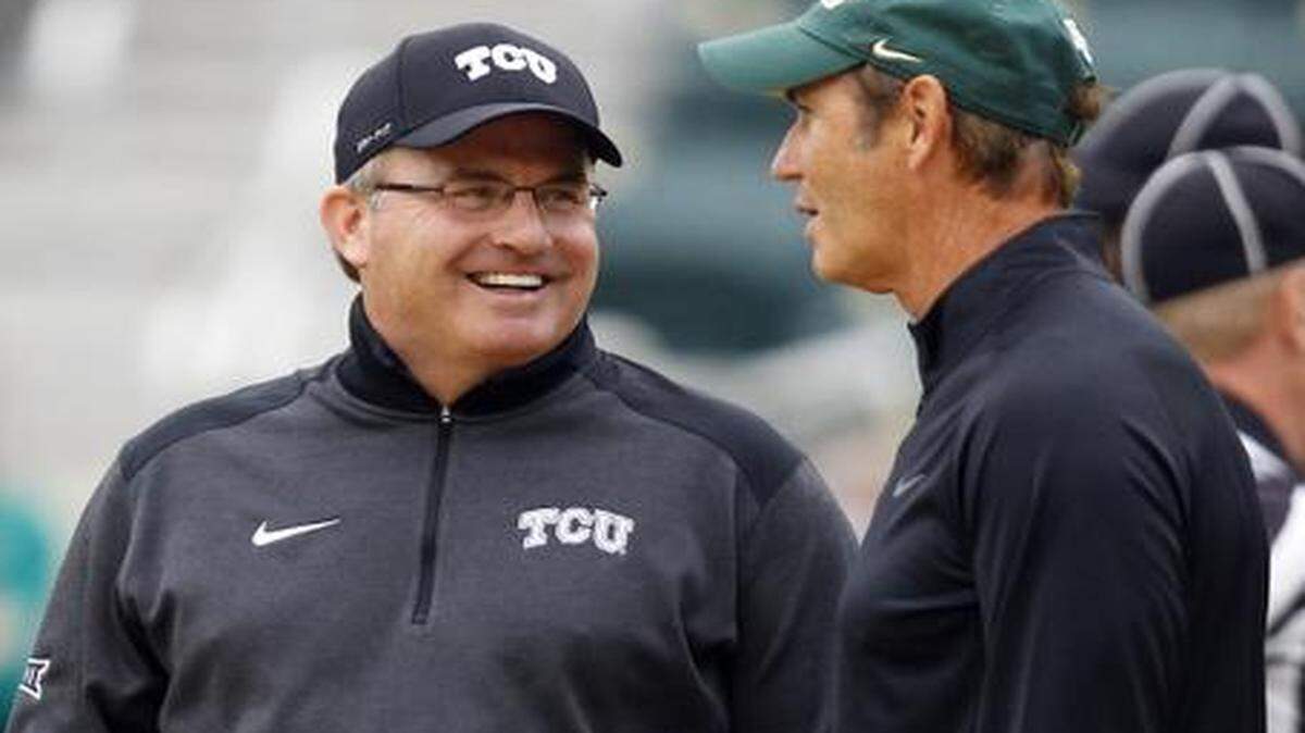 
TCU Horned Frogs head coach Gary Patterson and Baylor Bears head coach Art Briles chat during warmups before an NCAA football game at McLane Stadium Saturday, October 11, 2014. 
