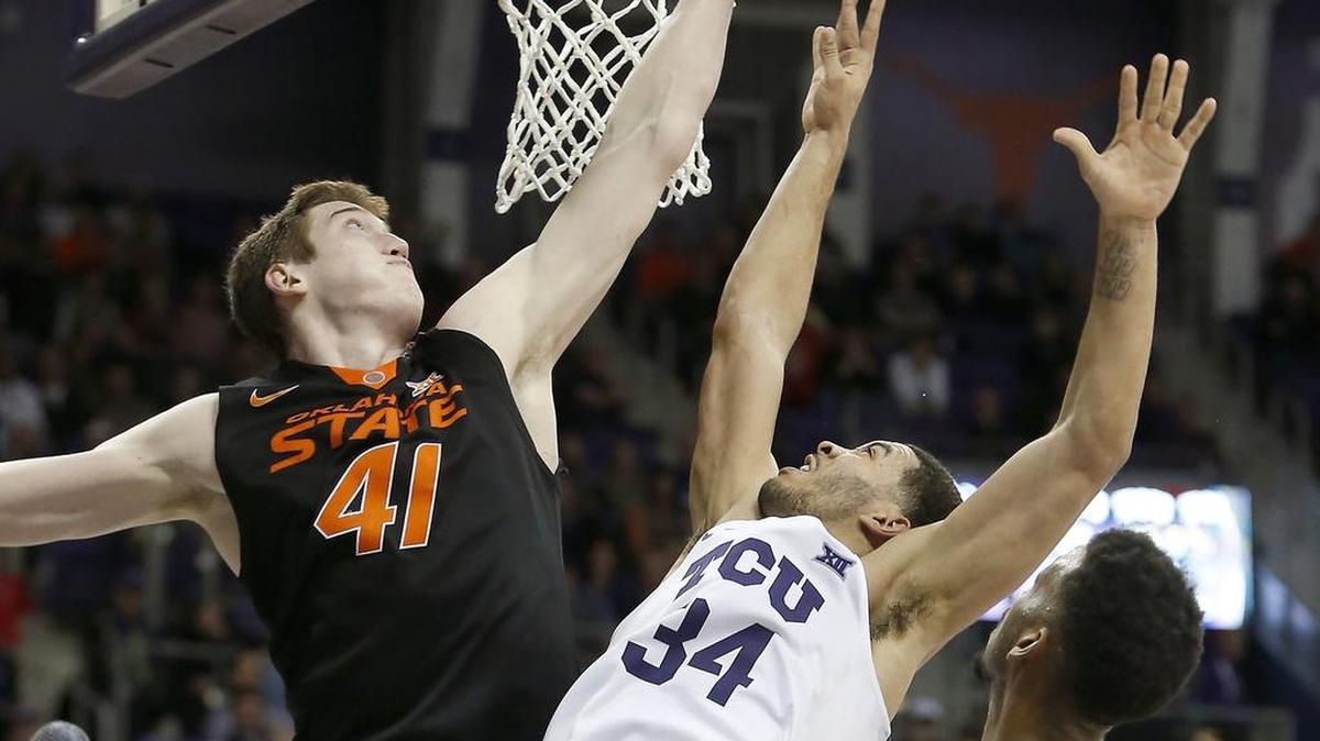 Oklahoma State Cowboys forward Mitchell Solomon (41) blocks the shot attempt by TCU Horned Frogs guard Kenrich Williams (34) in the first half of Wednesday’s game in Fort Worth.