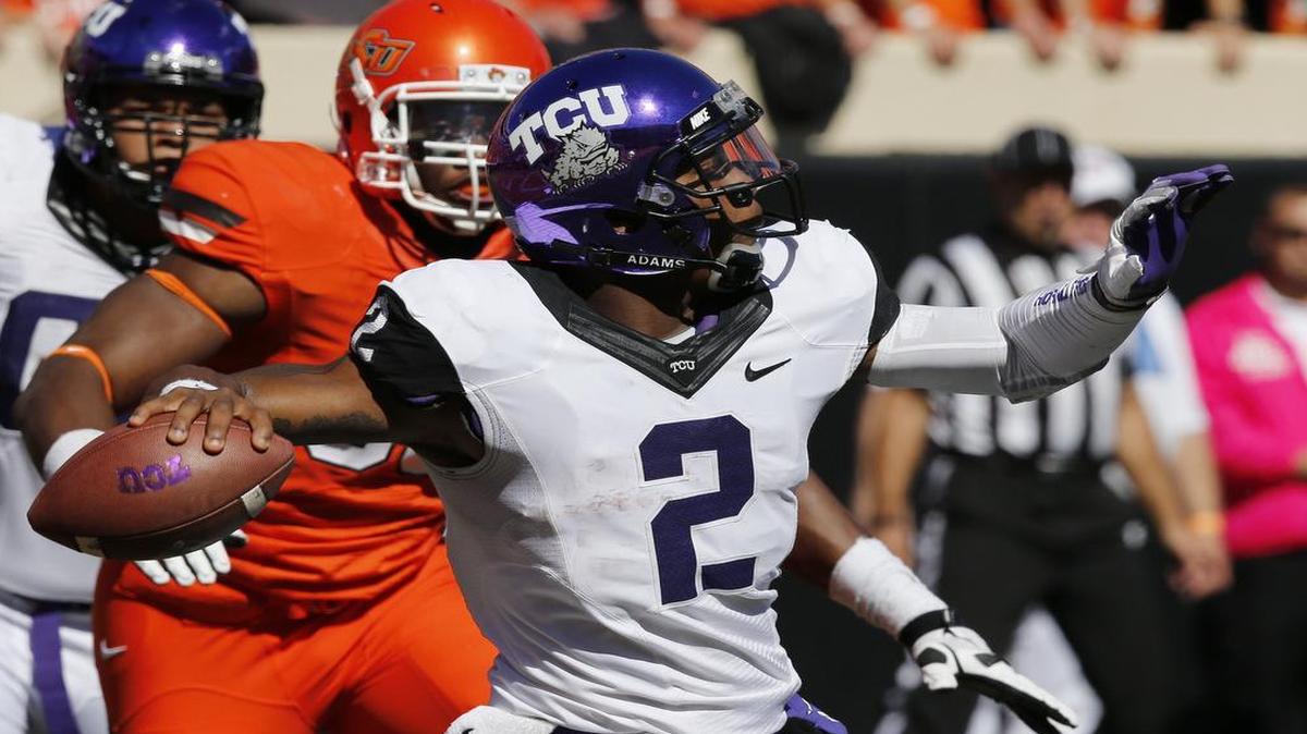 TCU quarterback Trevone Boykin looks downfield as pressure closes in from Oklahoma State’s Emmanuel Ogbah during a 2013 game in Stillwater, Okla. The Frogs and Cowboys will kick off their 2015 meeting at 2:30 p.m. on Nov. 7, the Big 12 announced. The game will be televised on FOX.