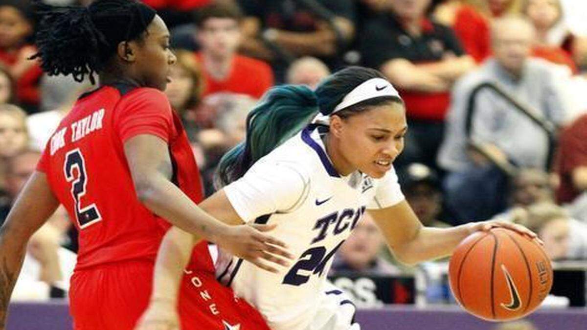 
TCU’s Natalie Ventress, right, has a green streak in her hair and in her game.



