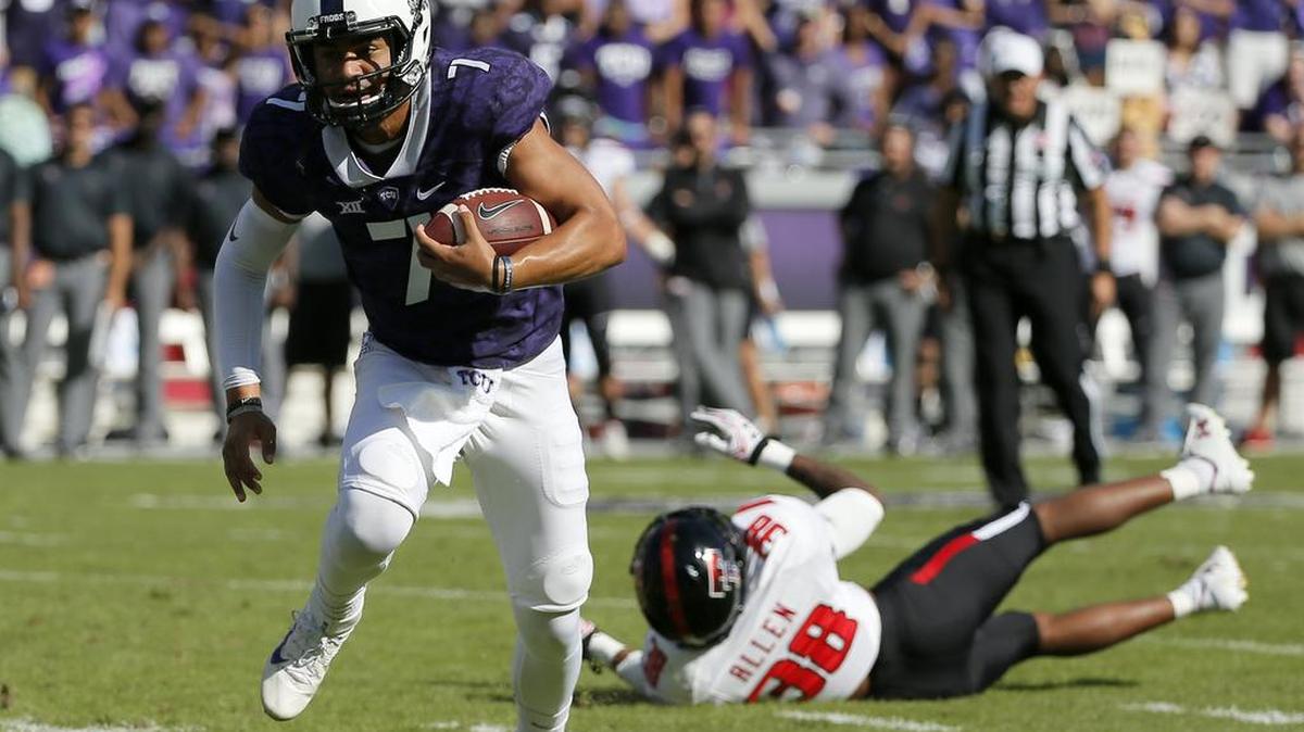 TCU quarterback Kenny Hill evades a tackle attempt by Texas Tech defensive back Kisean Allen in the first half.