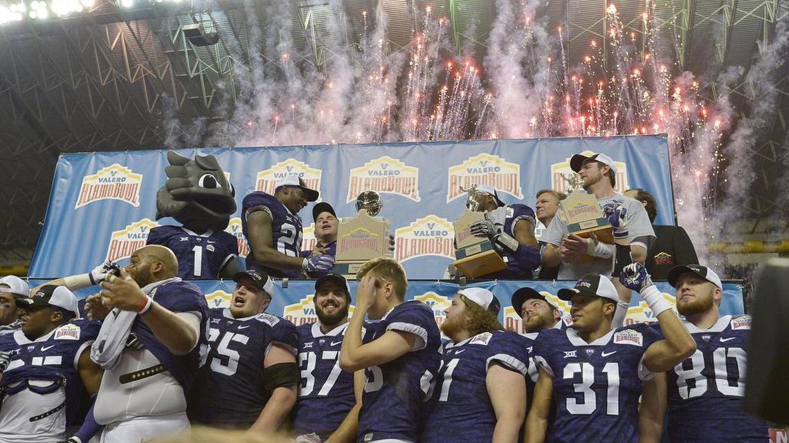 TCU players and coaches celebrate on the stage following a 47-41 triple-overtime victory against Oregon in the Alamo Bowl on Jan. 2, 2016.