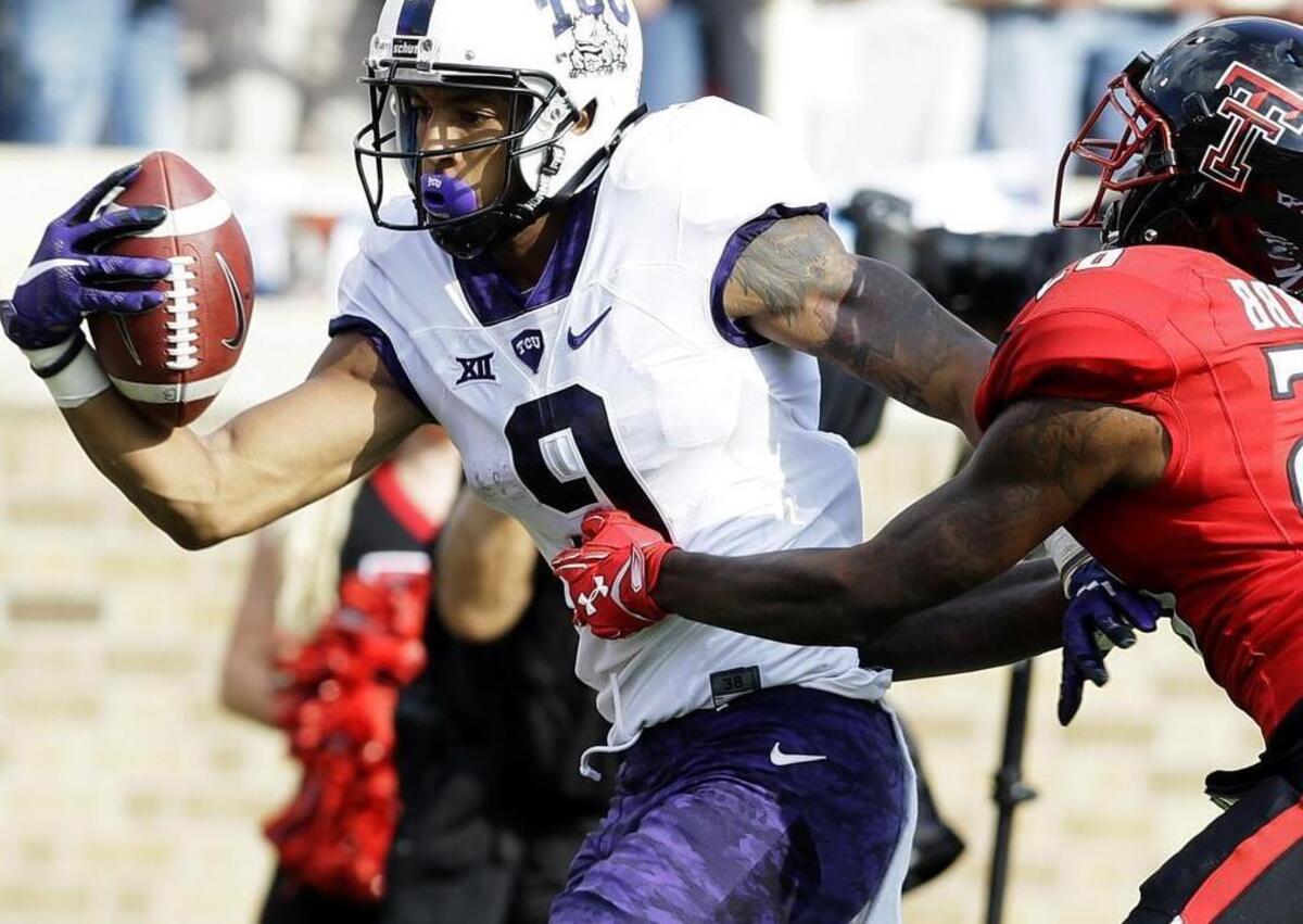 
TCU receiver Josh Doctson pulls in a pass for a touchdown against Texas Tech’s Paul Banks during the first quarter of last week’s game. Doctson had three touchdowns, giving him six for the season and 21 for his career at TCU -- one shy of the school record.
