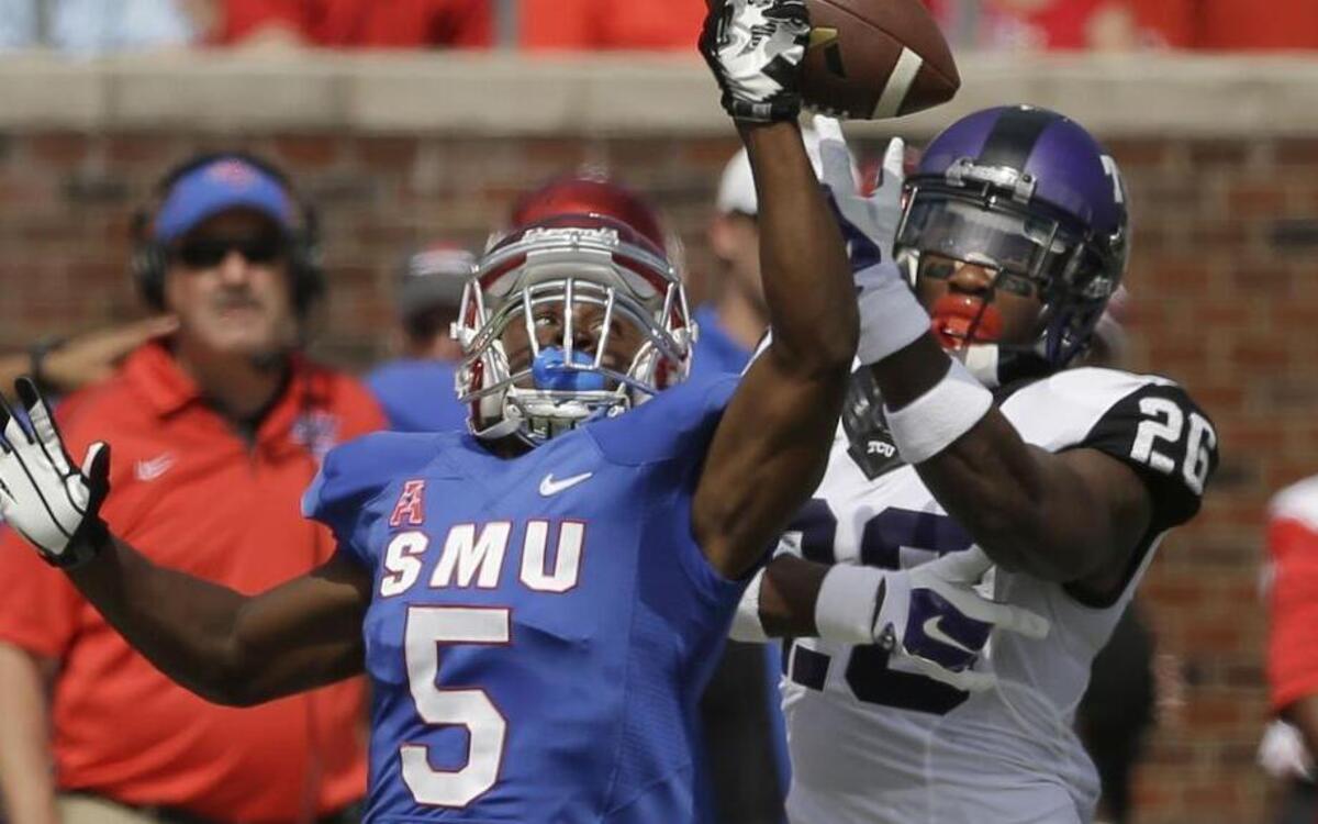 
SMU receiver Cedric Lancaster and TCU safety Derrick Kindred go for a pass in last year’s game. Kindred got the breakup, and the Horned Frogs got the victory, 56-0, to move ahead 47-40-7 all-time in the series.
