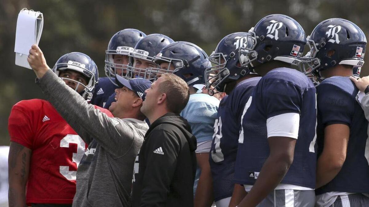 The Rice Owls get instruction for a play during a practice in Sydney, Australia, where they opened their season against Stanford on Saturday.
