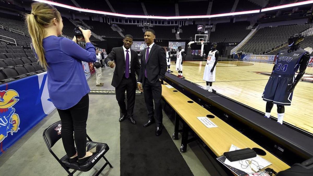 TCU videographer Kayla McLain gets creative with a chair to get on the same level with TCU players Chris Washburn (left) and Karviar Shepherd during Big 12 basketball media day at the Sprint Center in Kansas City, Mo.